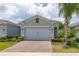 Inviting single-Gathering home with a well-maintained lawn, two-car garage and brick paver driveway at 1890 Flora Pass Pl, Kissimmee, FL 34747