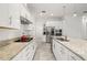 A modern kitchen boasts granite counters, stainless steel appliances, and white cabinetry at 1890 Flora Pass Pl, Kissimmee, FL 34747