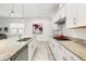 Spacious kitchen with granite countertops, stainless steel appliances, and white cabinetry at 1890 Flora Pass Pl, Kissimmee, FL 34747