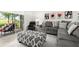 The cozy living room has comfortable seating and backyard access at 1890 Flora Pass Pl, Kissimmee, FL 34747