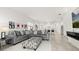 A well-lit living room offers easy access to the modern kitchen at 1890 Flora Pass Pl, Kissimmee, FL 34747