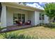 Relaxing outdoor patio with comfortable seating and a view of the well-maintained lawn at 1890 Flora Pass Pl, Kissimmee, FL 34747