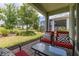 Covered outdoor patio featuring comfortable seating with view of landscaped backyard and green space at 1890 Flora Pass Pl, Kissimmee, FL 34747
