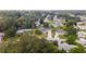 Aerial view of a residential area with single-Gathering homes surrounded by lush greenery and mature trees at 8225 Sw 108Th Street Rd, Ocala, FL 34481