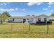 The property features a fenced backyard, providing a secure and private space for outdoor activities and relaxation at 8225 Sw 108Th Street Rd, Ocala, FL 34481