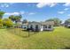Fenced backyard featuring a patio and lush lawn at 8225 Sw 108Th Street Rd, Ocala, FL 34481