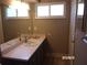 Neutral bathroom featuring a single sink vanity with a framed mirror and a window at 8225 Sw 108Th Street Rd, Ocala, FL 34481