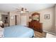 Cozy bedroom features wood floors, a large dresser, and neutral paint colors at 8225 Sw 108Th Street Rd, Ocala, FL 34481