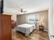 Comfortable bedroom with a queen-size bed, hardwood floors, and ample closet space at 8225 Sw 108Th Street Rd, Ocala, FL 34481
