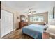 Inviting bedroom with wood floors, a closet, a window, a ceiling fan, and neutral paint at 8225 Sw 108Th Street Rd, Ocala, FL 34481