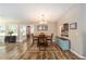 Charming dining room with hardwood floors and a view into the kitchen area at 8225 Sw 108Th Street Rd, Ocala, FL 34481