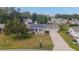 Charming single-story home featuring a well-maintained lawn, long driveway, and solar panels for energy efficiency at 8225 Sw 108Th Street Rd, Ocala, FL 34481