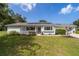 Charming one-story home featuring a well-kept lawn, solar panels, and an attached two-car garage at 8225 Sw 108Th Street Rd, Ocala, FL 34481