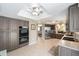 The kitchen has stainless steel appliances and an open design into the dining room and living areas at 8225 Sw 108Th Street Rd, Ocala, FL 34481