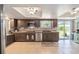 Spacious kitchen featuring stainless appliances, a breakfast bar, and sliding glass doors to the outside at 8225 Sw 108Th Street Rd, Ocala, FL 34481