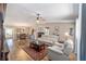 Open-concept living area with a leather sofa, hardwood floors, and dining area in the background at 8225 Sw 108Th Street Rd, Ocala, FL 34481