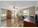 Bright living area with hardwood floors, ceiling fan, and natural light from the window at 8225 Sw 108Th Street Rd, Ocala, FL 34481