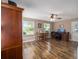 Living room featuring wood-look floors, a ceiling fan, windows and a desk with computer at 8225 Sw 108Th Street Rd, Ocala, FL 34481