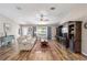 Bright living room with hardwood floors, comfortable seating, and stylish built-in entertainment center at 8225 Sw 108Th Street Rd, Ocala, FL 34481