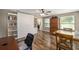 Living room featuring wood-look floors, windows, a ceiling fan, and office furniture at 8225 Sw 108Th Street Rd, Ocala, FL 34481