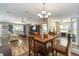 Open concept view of dining, living, and office spaces with wood flooring and natural light at 8225 Sw 108Th Street Rd, Ocala, FL 34481