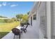 Back patio featuring outdoor furniture, a grill, and a view of the backyard at 8225 Sw 108Th Street Rd, Ocala, FL 34481