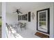 Inviting front porch with seating area, ceiling fan, decorative accents, and welcoming entrance at 8225 Sw 108Th Street Rd, Ocala, FL 34481