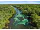 Breathtaking aerial perspective of a vibrant river lined with verdant trees and recreational boaters at 9700 Sw 196 Circle, Dunnellon, FL 34432