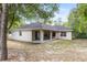 The backyard features green grass and large tree at 9700 Sw 196 Circle, Dunnellon, FL 34432