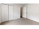 Neutral bedroom with carpet flooring and a double door closet for ample storage space at 9700 Sw 196 Circle, Dunnellon, FL 34432