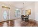 Dining area featuring wood-look floors, chandelier and plenty of natural light at 9700 Sw 196 Circle, Dunnellon, FL 34432