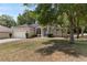 Charming single-story home with well-manicured lawn, mature trees, and attached two car garage at 9700 Sw 196 Circle, Dunnellon, FL 34432