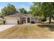 Charming single-story home featuring a well-manicured lawn and a two car garage at 9700 Sw 196 Circle, Dunnellon, FL 34432