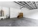 Clean garage with cement flooring, white walls, overhead door and water heater at 9700 Sw 196 Circle, Dunnellon, FL 34432