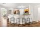 The eat-in kitchen features bar seating, stainless steel appliances and wood cabinets at 9700 Sw 196 Circle, Dunnellon, FL 34432