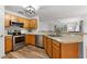 Functional kitchen featuring stainless steel appliances, wood cabinets, and wood-look flooring at 9700 Sw 196 Circle, Dunnellon, FL 34432