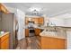 Functional kitchen featuring stainless steel appliances, wood cabinets, and wood-look flooring at 9700 Sw 196 Circle, Dunnellon, FL 34432
