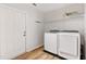 Well-lit laundry room with a white washer and dryer, and convenient overhead shelving at 9700 Sw 196 Circle, Dunnellon, FL 34432