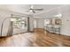 Open-concept living room with wood-look flooring and a view into the kitchen at 9700 Sw 196 Circle, Dunnellon, FL 34432