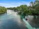 Scenic river view featuring crystal-clear waters and lush greenery, with boats enjoying the waterway at 9700 Sw 196 Circle, Dunnellon, FL 34432