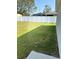 Lush green backyard enclosed by a white fence, offering privacy and space for outdoor activities at 15094 Sw 43Rd Avenue Rd, Ocala, FL 34473