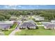 Aerial view of home with well-manicured lawn, mature trees, and pool at 629 Orange Valley Ln, Lakeland, FL 33813