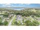 An aerial view of a neighborhood featuring tree-lined streets, manicured lawns and a home with a private pool at 629 Orange Valley Ln, Lakeland, FL 33813