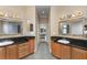 Long bathroom with dual sinks, granite countertop, and wood cabinets gives ample space at 629 Orange Valley Ln, Lakeland, FL 33813