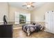 Cozy bedroom with ceiling fan and large window offering plenty of natural light at 629 Orange Valley Ln, Lakeland, FL 33813