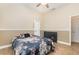 Comfortable bedroom has ceiling fan, wood floors, and is freshly painted in neutral colors at 629 Orange Valley Ln, Lakeland, FL 33813