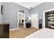 Bright bedroom features wood-look floors, gray walls, and white doors at 629 Orange Valley Ln, Lakeland, FL 33813