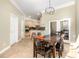 Open dining room flowing into the kitchen, featuring wood floors and access to the patio at 629 Orange Valley Ln, Lakeland, FL 33813