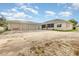 Exterior view of home with an oversized driveway, multiple garages, and lawn at 629 Orange Valley Ln, Lakeland, FL 33813