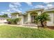 Inviting home featuring manicured landscaping, a palm tree, and a well-maintained front entrance at 629 Orange Valley Ln, Lakeland, FL 33813
